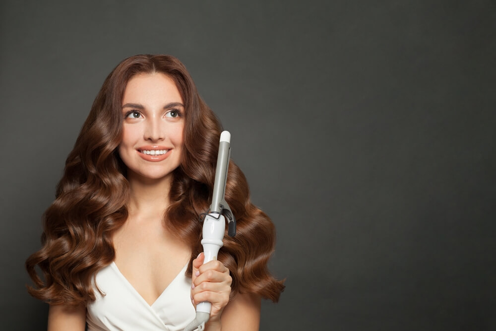 Charming,Brown,Haired,Woman,With,Shiny,Long,Curly,Hairstyle,Showing